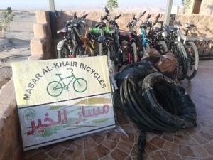 a group of bikes parked next to a wall at Feynan wild camp in Al Khuraybah