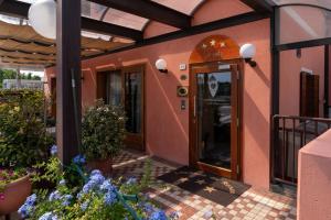 a building with a door and flowers in front of it at Locanda Da Renzo in Treviso
