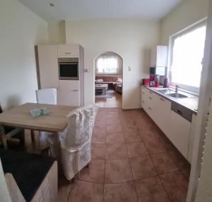 a kitchen with a table and a dining room at Ferienhaus Koehler in Lutherstadt Wittenberg