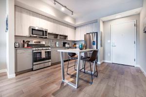 a kitchen with a table and chairs in it at Luxury Apt On Harbor in Stamford