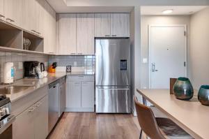 a kitchen with a stainless steel refrigerator at Luxury Apt On Harbor in Stamford +26 photos
