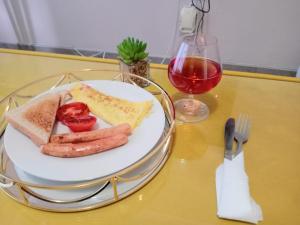 a plate of food with sausage and strawberries on a table at Winbert Apartments in Ladysmith