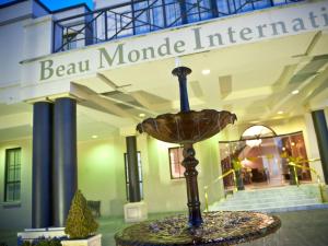 a sculpture in front of a building with a bear monde institute at Beau Monde International in Doncaster East