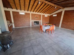 a room with a table and chairs and a fireplace at Sol y Sombra - Cabaña - Zonda - San Juan in Zonda