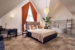 a bedroom with a large bed and a sink at Van der Valk Hotel Mechelen in Mechelen