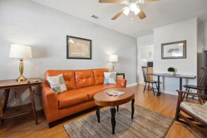 a living room with a couch and a table at Walkable Duplex Near Forsyth Park in Savannah
