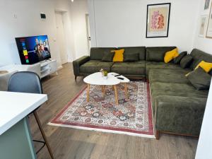 a living room with a couch and a table at Siera Tirana Apartment in Tirana