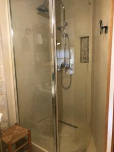a shower with a glass door in a bathroom at Le Joubert Hôtel Particulier in Uzès +20 photos
