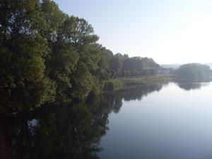 a river with trees on the side of it at Hôtel Des Alliés in Pont-dʼAin