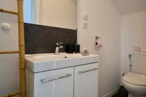a bathroom with a sink and a toilet at Blue Evy in Croix +19 photos