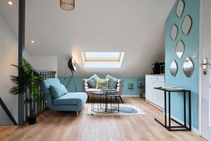 a living room with a blue couch and a chair at Blue Evy in Croix