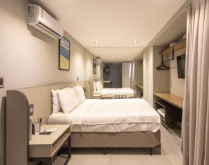 Cama ou camas em um quarto em Infinity at the Sea by Welkom mais 37 fotos