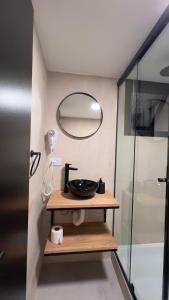 a bathroom with a sink and a mirror at Charcas Suites Palermo Soho in Buenos Aires