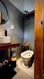 Un baño con un inodoro blanco y un lavabo. en Anastasia Rústica y acogedora, en Córdoba