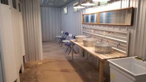 a room with a row of tables with buckets on it at Letchworth Valley Campground Cabins in Bliss