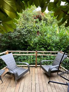 two chairs sitting on a wooden deck at Shed Gwely in Govilon