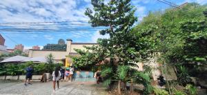 a group of people walking down a street at Yolo Hostel Medellin in Medellín
