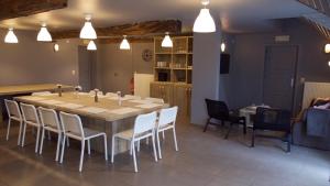 a dining room with a large table and chairs at Hof Ter Meulen in De Haan