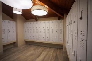 a locker room with white lockers and lights at Mount Snow Lodging in Dover