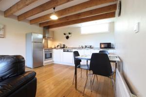 a kitchen and living room with a table and chairs at Chez fontaine in Lahonce