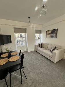 a living room with a couch and a table at Kingsmead Square Apartments in Bath