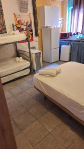 a dorm room with two beds and a refrigerator at Casa Xeneize Punta Candor in Cádiz