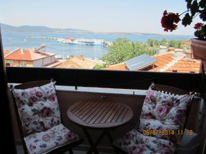 a balcony with two chairs and a view of the water at Guesthouse Olimp in Sozopol