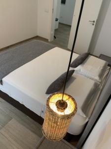 a bedroom with a bed with a lamp next to it at Alfa-apartamento in Pombas