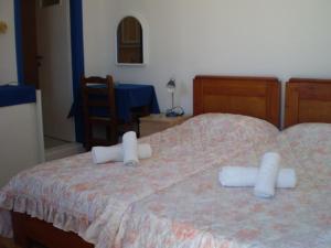 Cama ou camas em um quarto em Maria's Kouka Pension