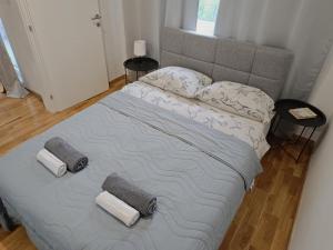 a bed with two pillows on it in a bedroom at ZARA Apartman in Bijeljina