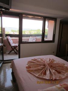 a room with a bed with a pillow on it at Guesthouse Olimp in Sozopol