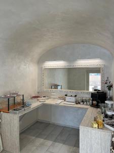 una grande cucina con un grande specchio sul muro di B&B Piccola Stella a Pisa