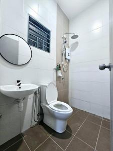 a bathroom with a toilet and a sink and a mirror at HM Residence IIII 3km - Setia City Convention in Shah Alam +11 photos