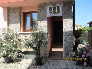 a house with a sign on the front of it at Guesthouse Olimp in Sozopol