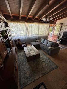 a living room with a couch and a coffee table at Giardino di Circe in Agrigento