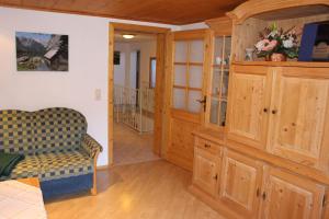 a living room with a couch and a cabinet at Ferienhof Bernegglehen in Berchtesgaden