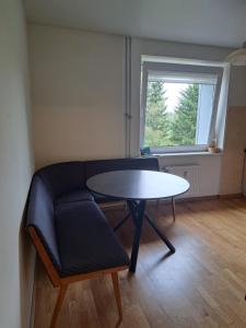 a living room with a table and a couch at Welcoming apartment in Anykščiai