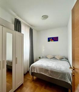 a bedroom with a bed and a window at Apartment Aurora in Buzin