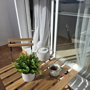 a table with two plants and a tea pot on a balcony at Casa Serena Alojamiento Rural in Enix +24 photos