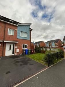 a parking lot in front of a house at Nice house close to the city centre and stadium in Manchester