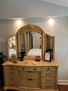 a wooden dresser with a mirror on top of it at Romantic Luxury W Infrared Sauna in Beaufort