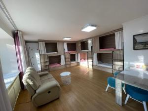 a living room with a couch and a table at Tumoko's Inn Hostel in Ulaanbaatar