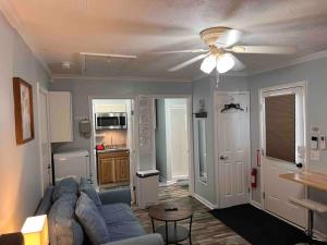 a living room with a couch and a ceiling fan at Cozy Studio Retreat. Pet Yes in Beaufort