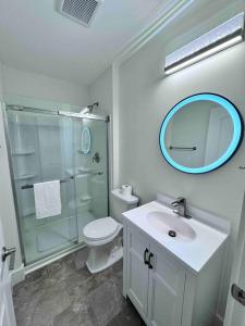 a bathroom with a toilet and a sink and a mirror at Modern Cottage Downtown. Pet Yes in Beaufort +56 photos