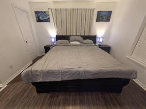 a bedroom with a large bed with two night stands at Pet Friendly Sleeps 9 HighSpeed WiFi 500MBPS Plus in Fresno