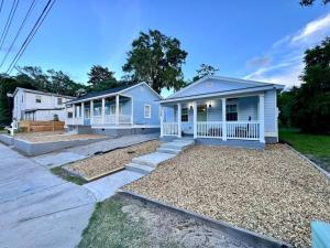 a blue house with a porch and a yard at Modern Cottage Downtown. Pet Yes in Beaufort