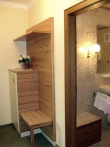 a bathroom with a walk in shower and a sink at Pension Schlömmer in Sankt Gilgen