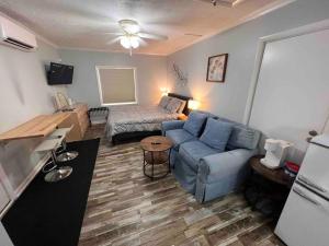 a living room with a blue couch and a bed at Cozy Studio Retreat. Pet Yes in Beaufort