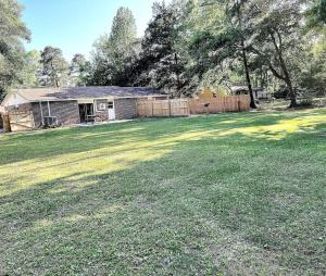 a yard with a house and a fence at Cozy Studio Retreat. Pet Yes in Beaufort