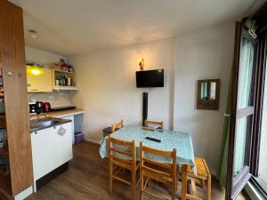 a kitchen and dining room with a table and chairs at Le Serre d Aigle in Saint-Chaffrey +10 photos